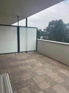 an empty balcony with whiteboards on a wall at Riverside Apartment Szeged in Szeged