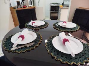 a table with plates and napkins on top of it at Studio Premium in Franca