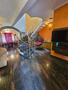a living room with a spiral staircase in a house at Homestay near Kochi Airport in Ernakulam