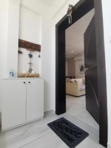 a room with a black door and a black rug at Dolce Far Niente Apartment in Kalamata