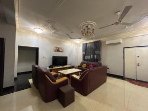 a living room with two couches and a table at Luxurious 5 Bedroom Mansion at East Legon in Accra