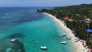 an aerial view of a beach with boats in the water at Naboo Resort & Dive Center - Adults Only in West Bay