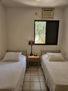 En eller flere senge i et værelse på Apto 337 super bem localizado + 16 billeder