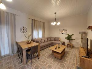 a living room with a couch and a table at Stone-built Villa Nesseris 80 m2 in Preveza