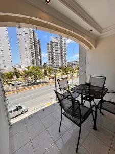 a balcony with two tables and a view of a street at Casa Bonampak 1 in Cancún