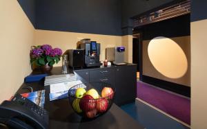 a bowl of fruit on a table in a room at Aare Lodge Attisholz Self Check-in in Luterbach