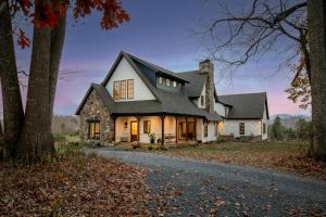 a white house with a black roof at The Indigo House, an adults only, modern bed and breakfast for outdoorsy humans and kind dogs in Afton