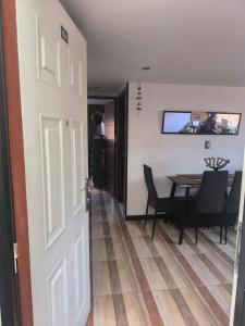 a door leading into a dining room with a table at Apartamento cerca al Aeropuerto in Bogotá