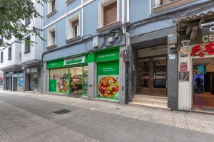 a row of store fronts on a city street at Tu hogar en Bilbao para 4 personas in Bilbao