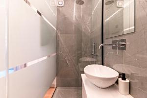 a bathroom with a toilet and a glass shower at Cozy 2-Bedroom by Flisvos Marina in Athens +39 photos