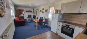 a kitchen with a table and a living room at 3***Ferienwohnungen Neumann in Dändorf