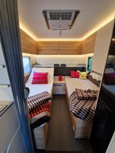 a small room with two beds in a trailer at Przyczepa ADORA nad morzem in Rumia