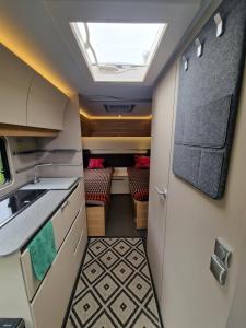 an interior view of an rv kitchen with a skylight at Przyczepa ADORA nad morzem in Rumia