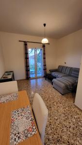 a living room with a couch and a table at Filippos Apartments "Apartment 1" in Kefallonia
