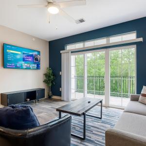 a living room with a couch and a table at IRIE Living Divine Kg 2bd Gym Pool Brand New in Whitestown