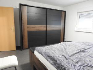 a bedroom with a bed with a black headboard at Ferienwohnung Am Fischerhof 10a Wernigerode in Wernigerode