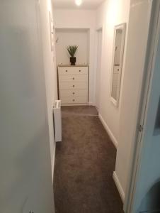 a hallway with a dresser and a chest of drawers at Coach House Apartment - Sleeps 2 in Whitehaven