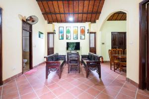 a living room with a table and chairs at Lumiere Family Village Ba Vì in Ba Vì