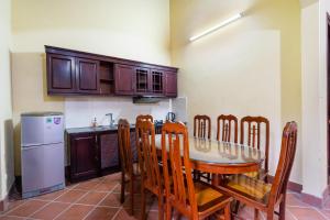 a kitchen with a table and chairs and a refrigerator at Lumiere Family Village Ba Vì in Ba Vì +88 photos