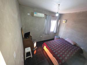 a small bedroom with a bed and a window at Queen's Cross in Santa Lucía