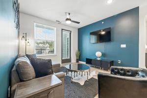 a living room with a couch and a table at IRIE Living Brand New Lux 2BR Min Grand Park in Westfield