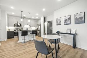 a kitchen and living room with a table and chairs at IRIE Living Brand New Lux 2BR Min Grand Park in Westfield