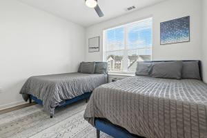 a bedroom with two beds and a window at IRIE Living Brand New Lux 2BR Min Grand Park in Westfield +35 photos