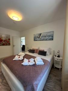 a bedroom with a large bed with towels on it at Appartement Ellara Penthouse in Žrnovo