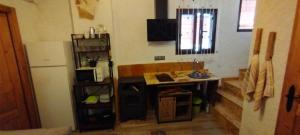 a small kitchen with a table and a microwave at Casa abuelo Kalinas in Cazorla