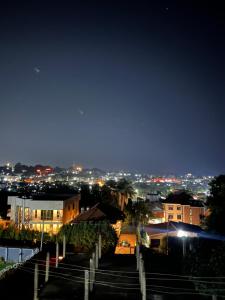 a view of a city at night with lights at HA LUXURY 3BEDROOM LAKEVIEW munyonyo in Kampala