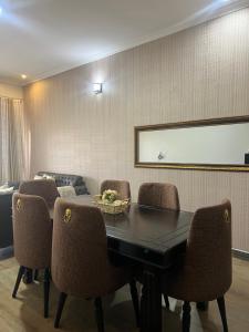 a conference room with a black table and chairs at HA LUXURY 3BEDROOM LAKEVIEW munyonyo in Kampala +26 photos