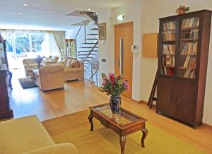 a living room with a vase of flowers on a coffee table at Villa Mon Repos Bed & Breakfast in Colera