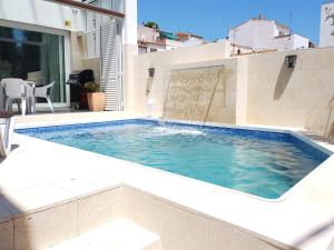 a swimming pool on the side of a building at Villa Mon Repos Bed & Breakfast in Colera