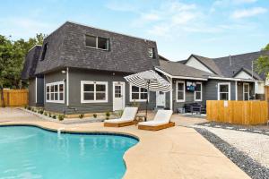 a house with a swimming pool in front of a house at Spacious Retreat with Pool & Hot Tub - 10 Minutes to Downtown in San Antonio