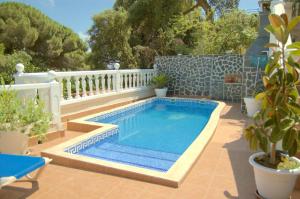a swimming pool on a patio with plants and a fence at casa vacacional con piscina privada in Sant Cebrià de Vallalta