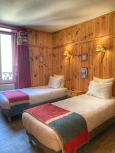 Postel nebo postele na pokoji v ubytování Hôtel Quin Te Va