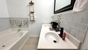 a bathroom with a sink and a bath tub at Christmas 3BR , King and Queen Beds , Uptown Charlotte in Charlotte +52 photos