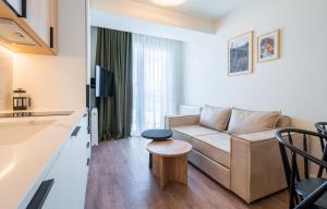 a living room with a couch and a table at Evdo Apartments F1 Modern house in Kʼumlistsʼikhe