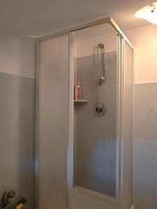 a shower with a glass door in a bathroom at Casa di Ulisse - mansarda familiare in Mandia