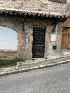 a stone building with a door on the side of it at Historic center apartment in Annonay