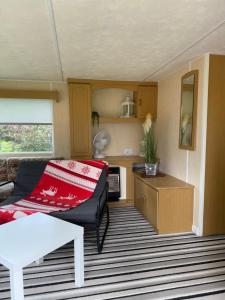 a living room with a couch and a table at Butterfly in Zvejniekciems