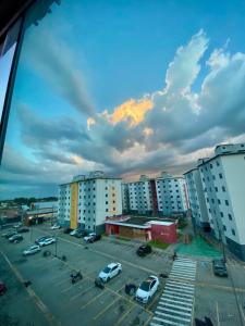 a view of a parking lot with buildings and cars at Cozy apartment-COP 30 in Ananindeua
