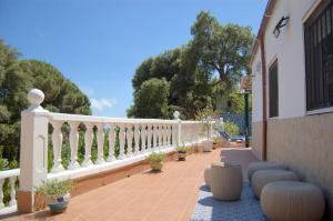 a balcony with a white railing and some plants at casa vacacional con piscina privada in Sant Cebrià de Vallalta