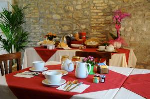 a table with a red and white table cloth on it at Casa Pellis in Fagagna