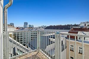 a view of a city from a balcony at Odeon Designer Apartments and Rooms I Self Check In in Vienna