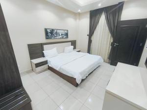 Ένα ή περισσότερα κρεβάτια σε δωμάτιο στο شقق فاخـرة ViP