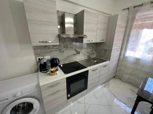 a kitchen with a sink and a washing machine at Casa Ale in Ventimiglia