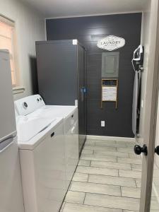 a bathroom with a sink and a shower in it at HomeSuite Cabin near Choctaw Casino Fun in Hugo +26 photos