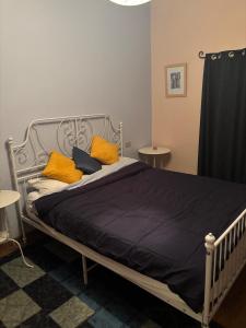 a bed with yellow pillows on it in a bedroom at Casa Hemingway, Near Assisi in Armenzano