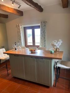 a kitchen with a large island with a wooden counter top at Casa Hemingway, Near Assisi in Armenzano